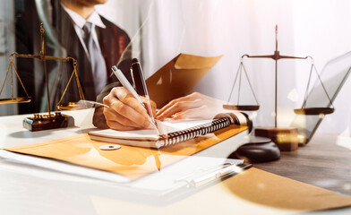 Justice and law concept.Male judge in a courtroom with the gavel, working with, computer and...