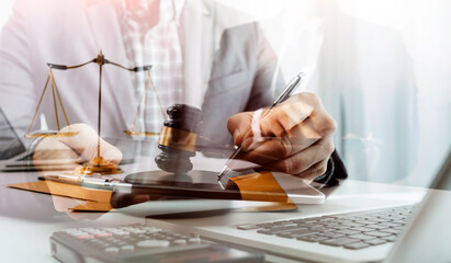 Business and lawyers discussing contract papers with brass scale on desk in office. Law, legal services, advice, justice and law concept