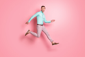 Fototapeta na wymiar Full length profile side photo of happy cool man run jump air copyspace wear brown shoes isolated on pink color background
