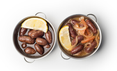 Lebanese starters of Makanek meat marinated, sausages fried in a metal pan isolated on white, clipping path included.