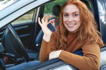 Fototapeta na wymiar Portrait of young woman ready to drive her new car