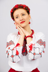 A girl, dressed in national Ukrainian clothes, with deep emotion and an exciting look.