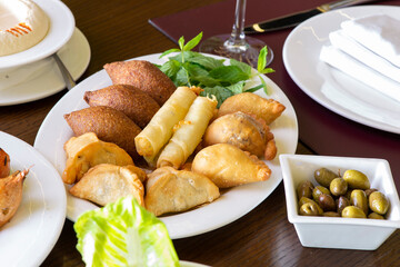 Lebanese Plate of Kebbeh, cheese rolls, and meat pie.