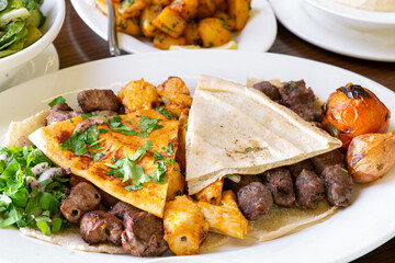 Lebanese Mixed Grill plate isolated on white.