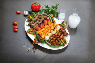 Lebanese Mixed Grill plate with arak  on a dark background