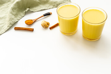 Yellow golden turmeric milk or pumpkin latte with ginger and cinnamon