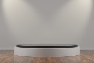 Dark gray and white cylinder podium in a room with 
white wall and wooden floor illuminated with two spotlights.