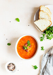 Hot and spicy, thick lentil and red bean soup with canned tomatoes and coriander. Concrete background. Top view.