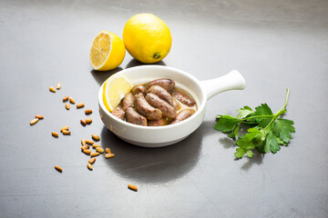 Lebanese starters of Makanek meat marinated, sausages fried in a frying pan.