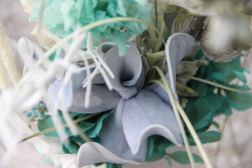 floral center detail with eucalyptus leaves and preserved flower