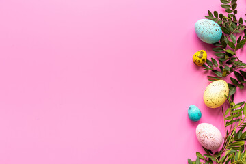 Happy Easter with colorful eggs and green branch, top view