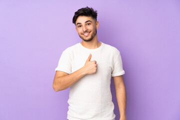 Arabian handsome man over isolated background giving a thumbs up gesture