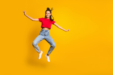 Fototapeta na wymiar Full size photo of attractive carefree dark skin person jumping beaming smile isolated on yellow color background