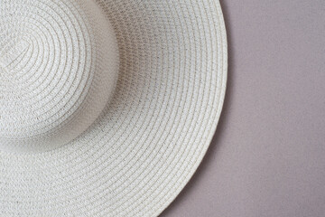 Fototapeta na wymiar A large white beach lady's hat on a pastel beige background. The concept of vacation, vacation, travel, sales, black Friday.