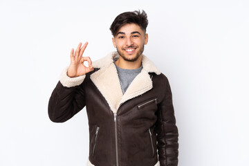 Arabian handsome man over isolated background showing ok sign with fingers