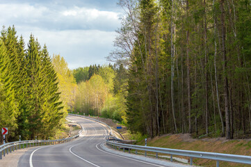 Fototapeta premium Winding road down the hill in spring.