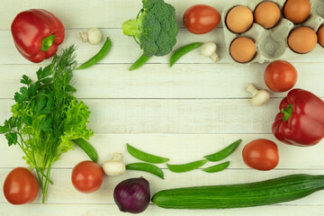 On the table are products for an omelet with lard and vegetables. Place for text