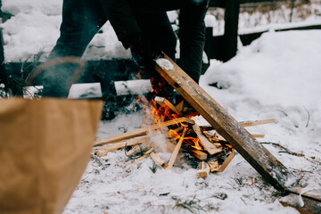 Lighting a fire in the forest in winter
