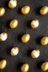Pattern of golden eggs. Easter decoration. Wealth and good luck concept. Overhead view