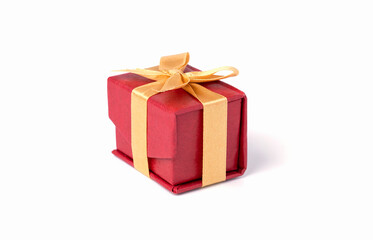 Red gift box and golden ribbon on white and bokeh background, Happy birthday and happy new year concept.