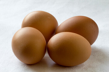 Four eggs on a white table cloth
