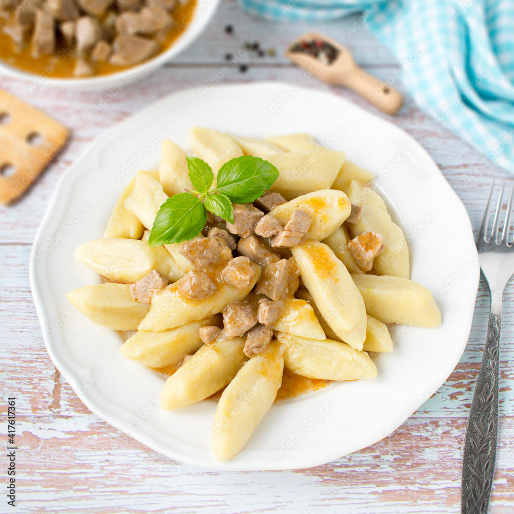 Wall mural Potato dumplings with pork goulash sauce. Kopytka.