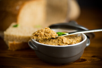 homemade meat pate in a ceramic bowl on a wooden table