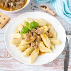 Potato dumplings with pork goulash sauce. Kopytka.