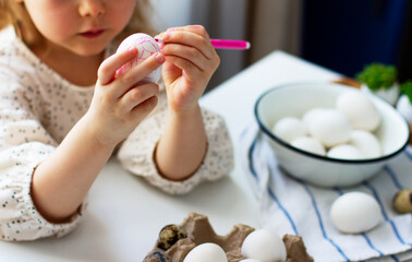 Little girl paints easter eggs. Easter concept. Preparing for Easter. Happy easter.