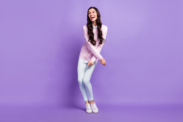 Fototapeta na wymiar Full length body size view of pretty amazed cheerful wavy-haired girl dancing having fun fooling isolated on violet color background
