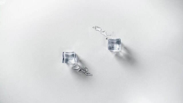 Stop motion animation of melting ice cubes moving around; loading animation; spring is coming