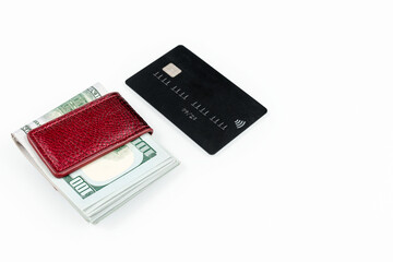 Stack of american dollars cash and black credit card isolated on a white background