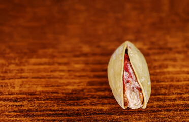 One Pistachio nuts a lot on wood macro image