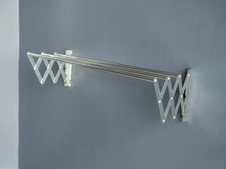 Aluminium folding clothes drying rack on the wall.