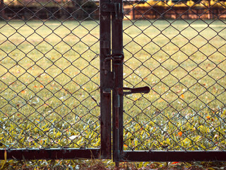 Closed old outdoor fence gate.