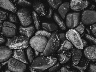 Black pebbles background texture.