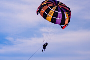Parasailing in blue sky. Sports, active leisure, travel, vacation concept