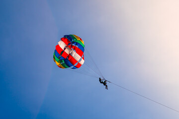 Parasailing in blue sky. Sports, active leisure, travel, vacation concept