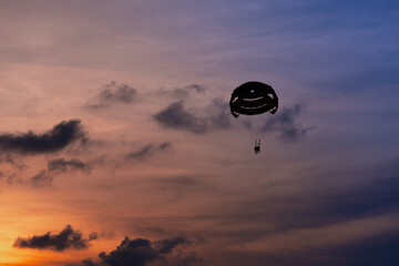 Parasailing in blue sky. Sports, active leisure, travel, vacation concept