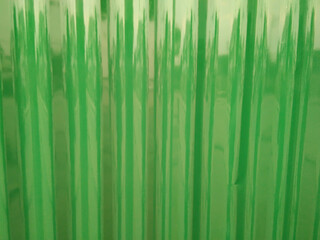 Abstract light colored galvanized sheet with shiny green background.
