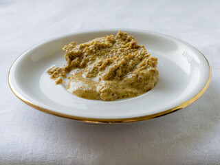 Mustard on a white saucer