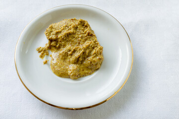 Mustard on a white saucer