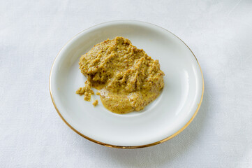 Mustard on a white saucer