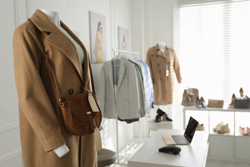 Collection of stylish women's clothes and accessories in modern boutique