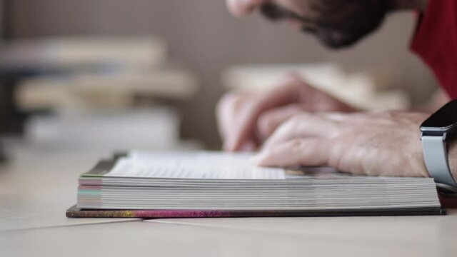 Man's hand flipping textbook pages. learning concept, closeup shot