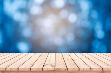 Wood table or wood floor with abstract blue bokeh background for product display 