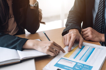 Close-up of a business people analyzing working at the office.