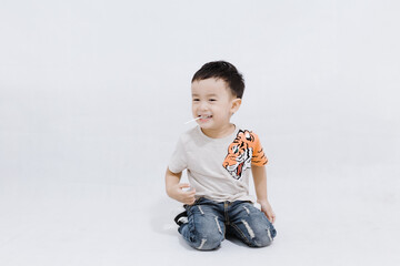 boy eats lollipops on white background