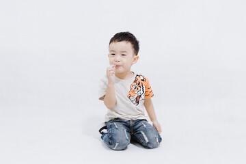 boy eats lollipops on white background