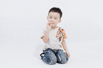 boy eats lollipops on white background